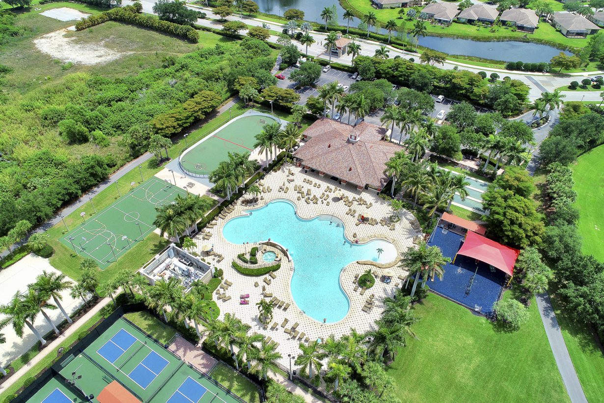 Bella Terra amenity campus aerial — resort pool, pickleball, basketball, and clubhouse