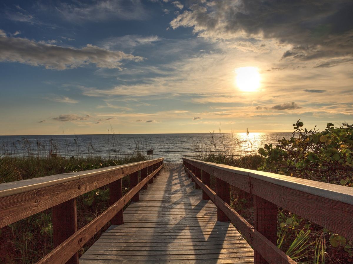 Boardwalk through dunes to a Gulf beach at sunset